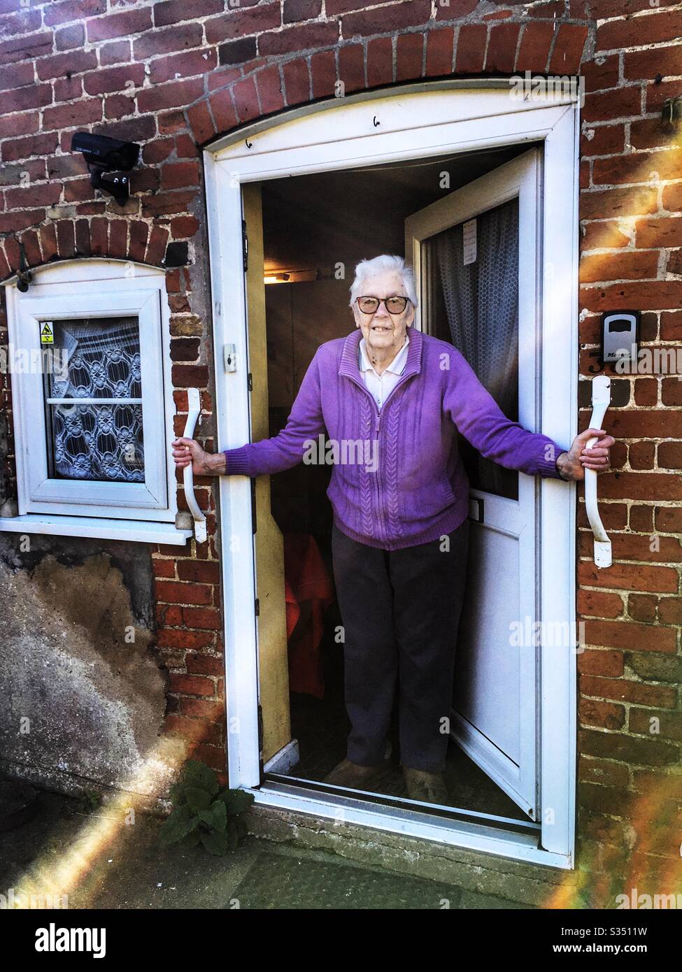Elderly woman self isolating at home during the lockdown because of Coronavirus 2020 - Smartphone Captured Stock Image