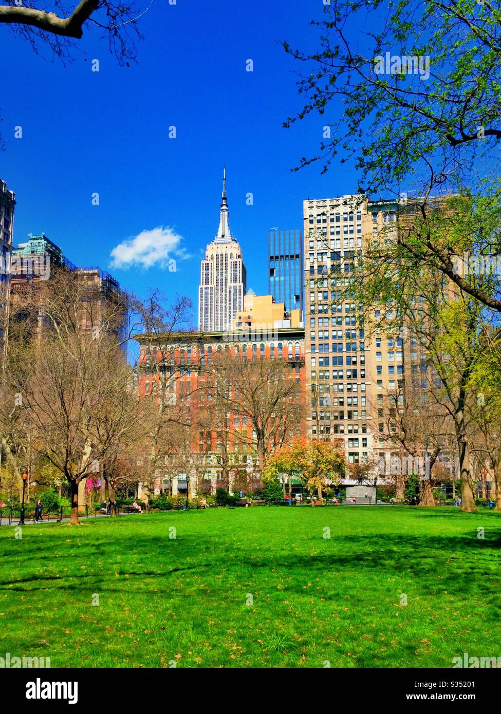 The Empire State building can be seen from Madison Square, Park in the early spring time, NYC, USA - Smartphone Captured Stock Image