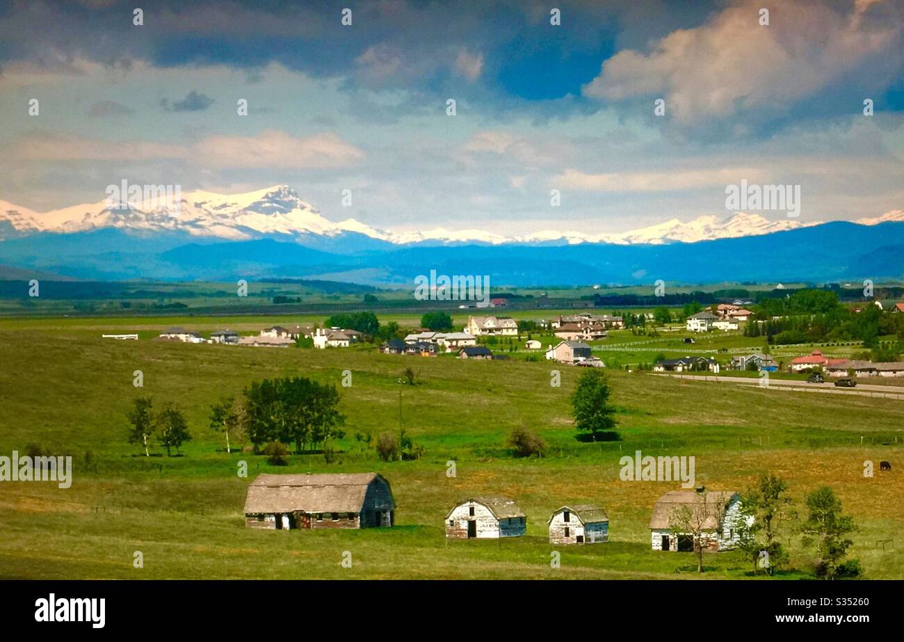 Old farmyard barns, agriculture, country life, wooden, structures,  Alberta, Canada, mountains, foothills, residential subdivision, Calgary , - Smartphone Captured Stock Image