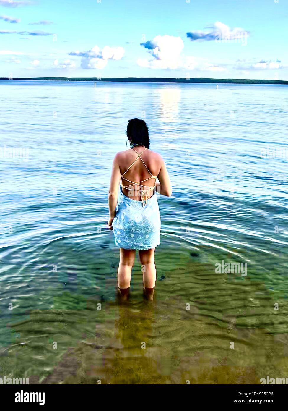 Woman wading in Higgens Lake northern Michigan - Smartphone Captured Stock Image