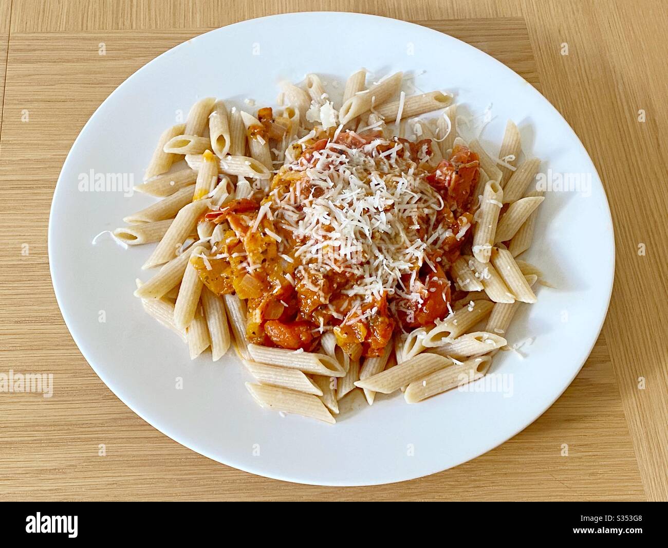 Penne pasta with rustic tomato sauce and grated Parmesan cheese - Smartphone Captured Stock Image