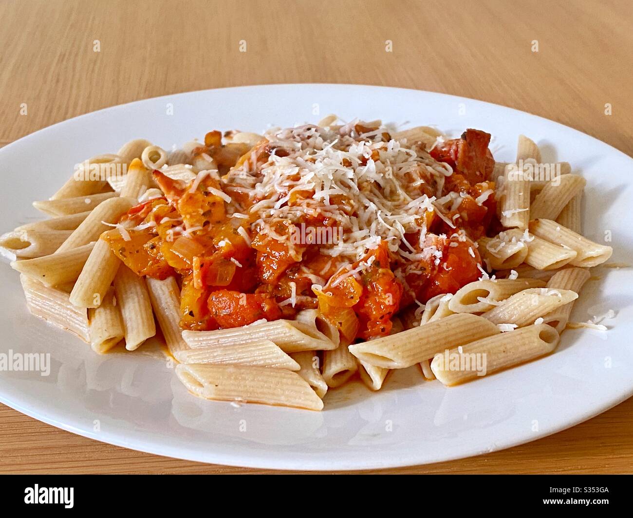 Penne pasta with rustic tomato sauce and grated Parmesan cheese Stock Photo