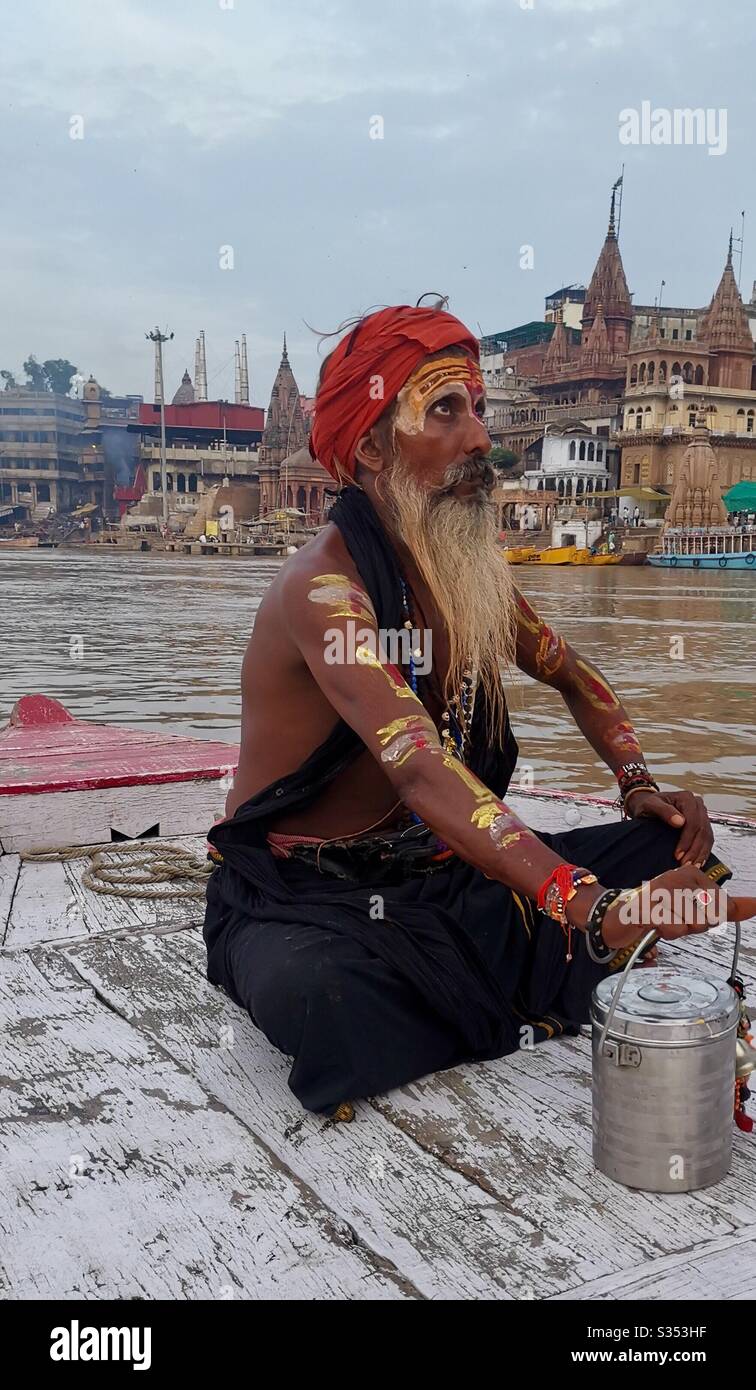 A Hindu sadhu praying on the Ganges river in India. - Smartphone Captured Stock Image