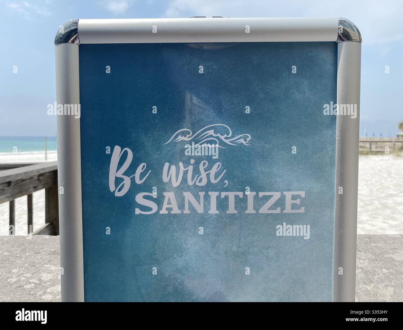 Sign on the beach reminding public to sanitize their hands Stock Photo