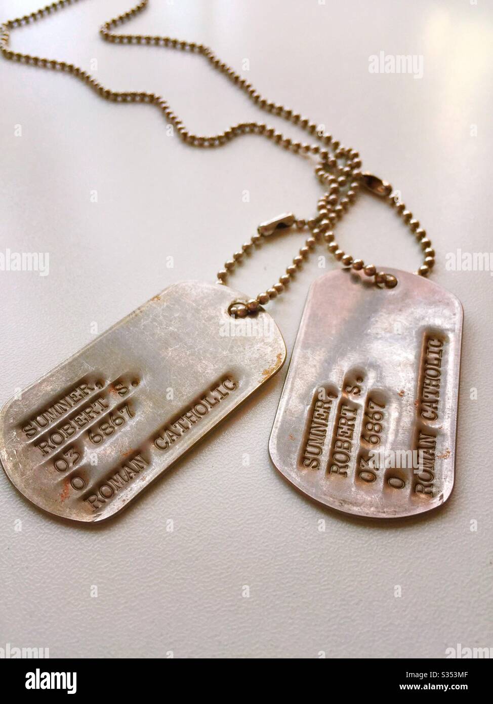 Close up of World War II era identification tags in chain, 1940s, USA - Smartphone Captured Stock Image