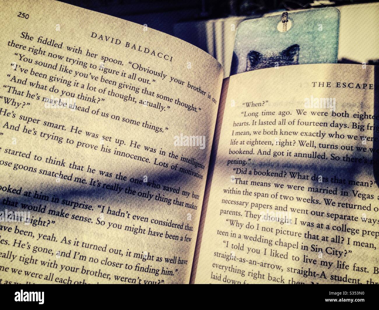 A David Balducci novel open with shadows across the page, USA - Smartphone Captured Stock Image
