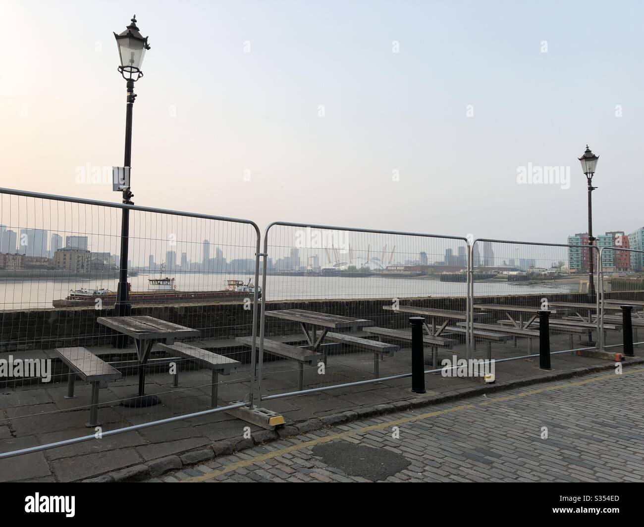 Fenced off tables of a pub in south London during the coronavirus lockdown. - Smartphone Captured Stock Image