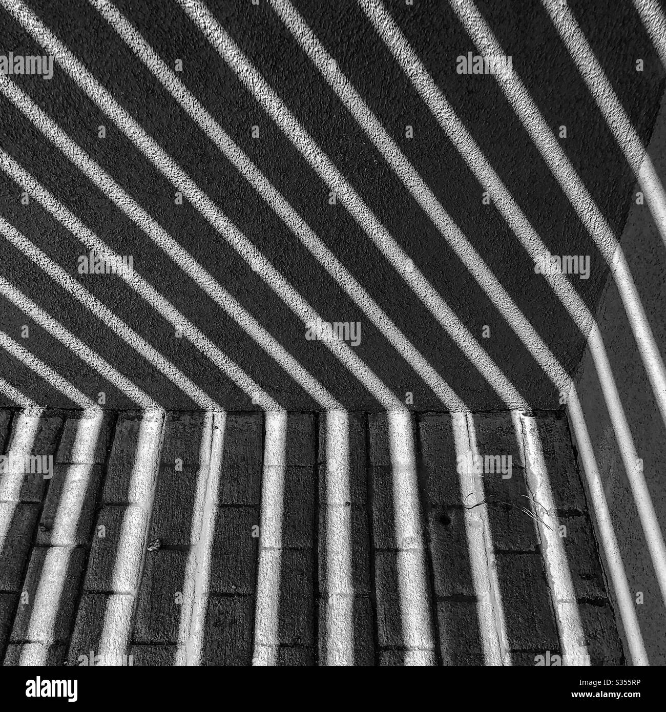 Black white filter, abstract, lines, angles, shadows, cement building walls, bricks, walkway, wood sunshade, wood boards construction, natural ventilation, backdrop, copy space Stock Photo