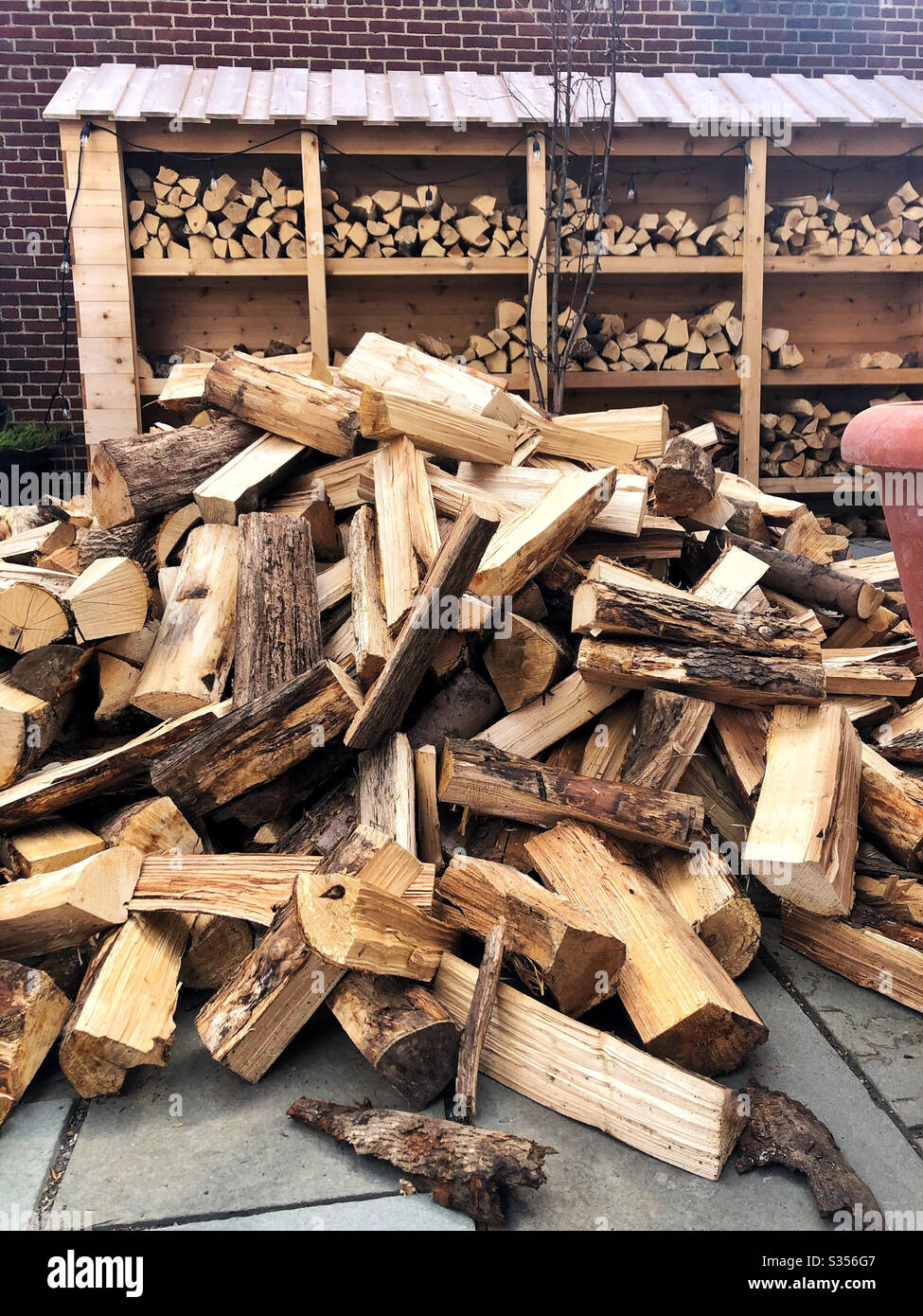 Wood delivery pile to be stacked a wood-fired pizza restaurant - Smartphone Captured Stock Image
