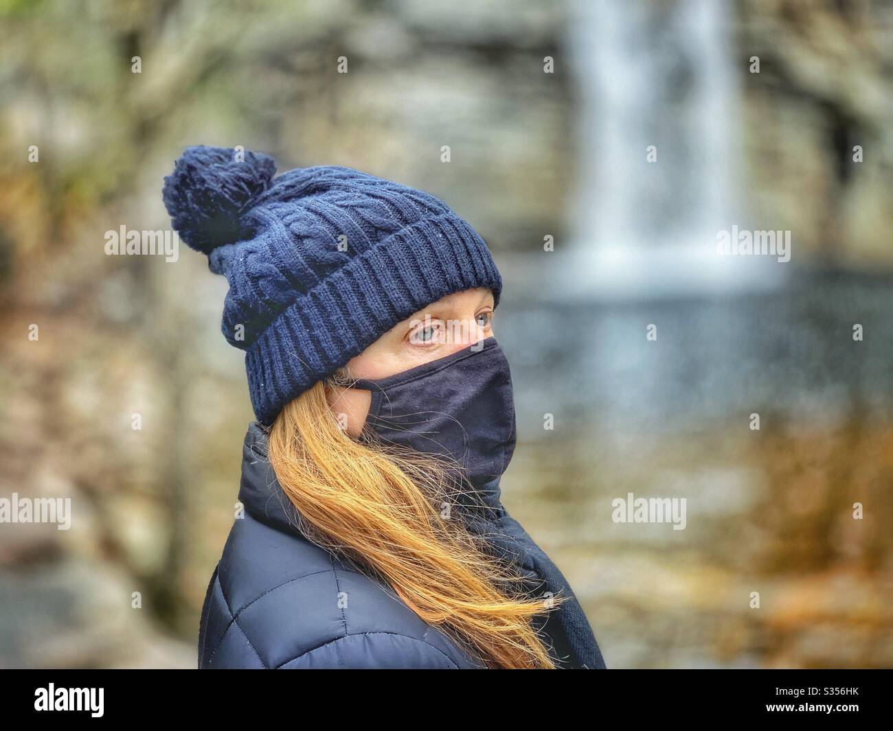 Woman outside for a walk with black mask - Smartphone Captured Stock Image