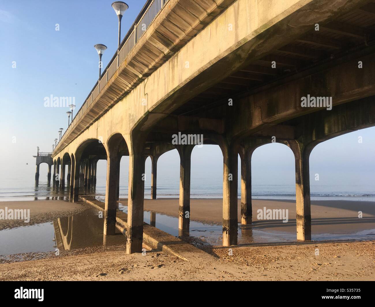 Reflections at low tide under Boscombe Pier, Bournemouth, Dorset, UK Stock Photo