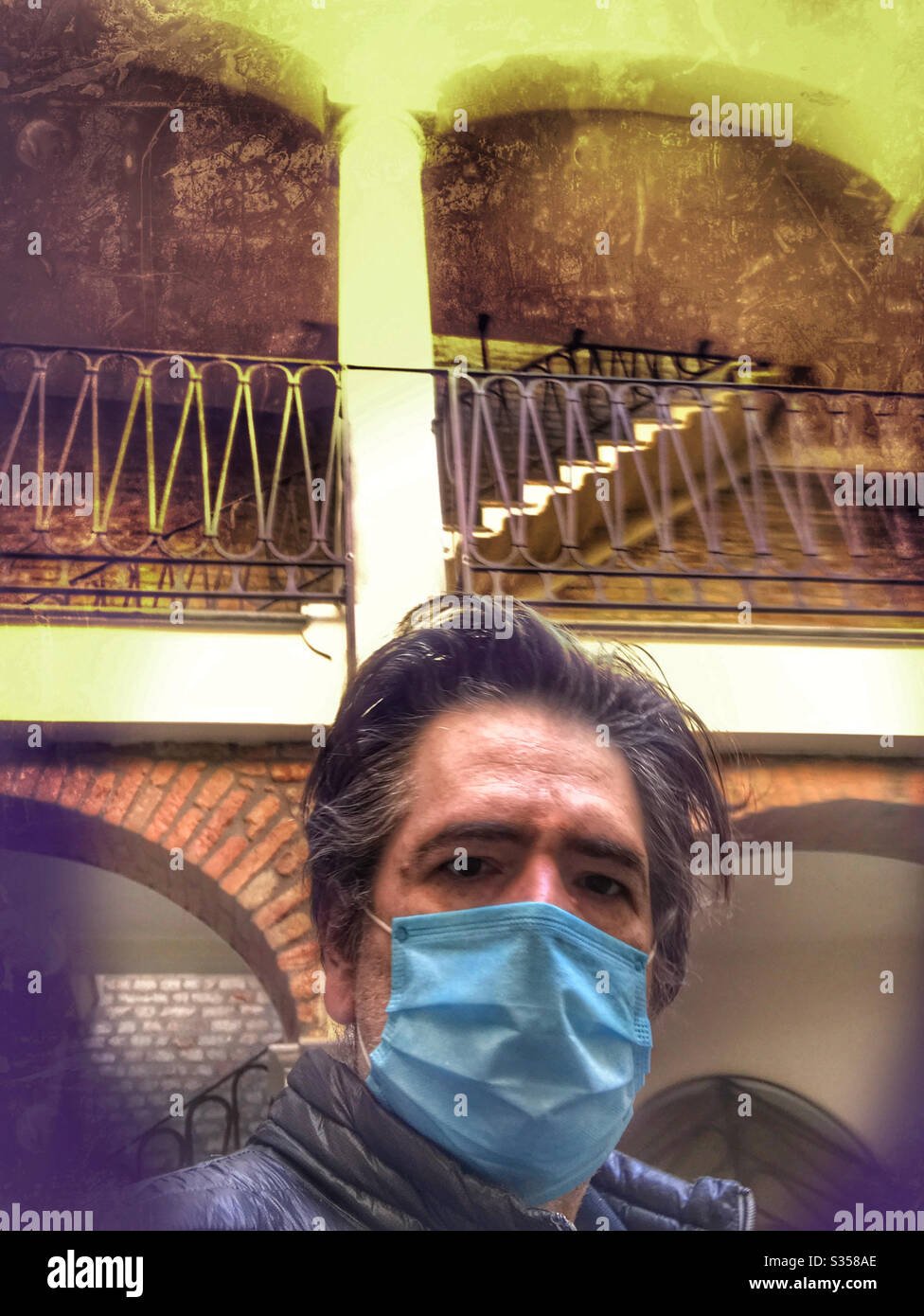 Man standing wearing a surgical face mask - Smartphone Captured Stock Image