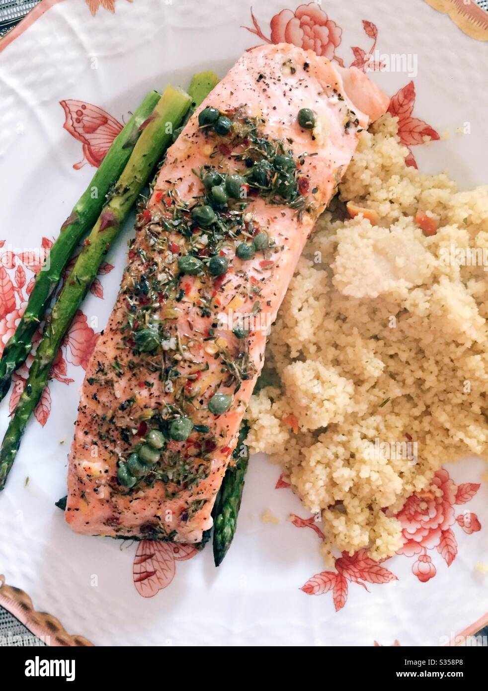 Close up of a balanced meal of baked salmon fillet, fresh asparagus spears and couscous on a china plate - Smartphone Captured Stock Image