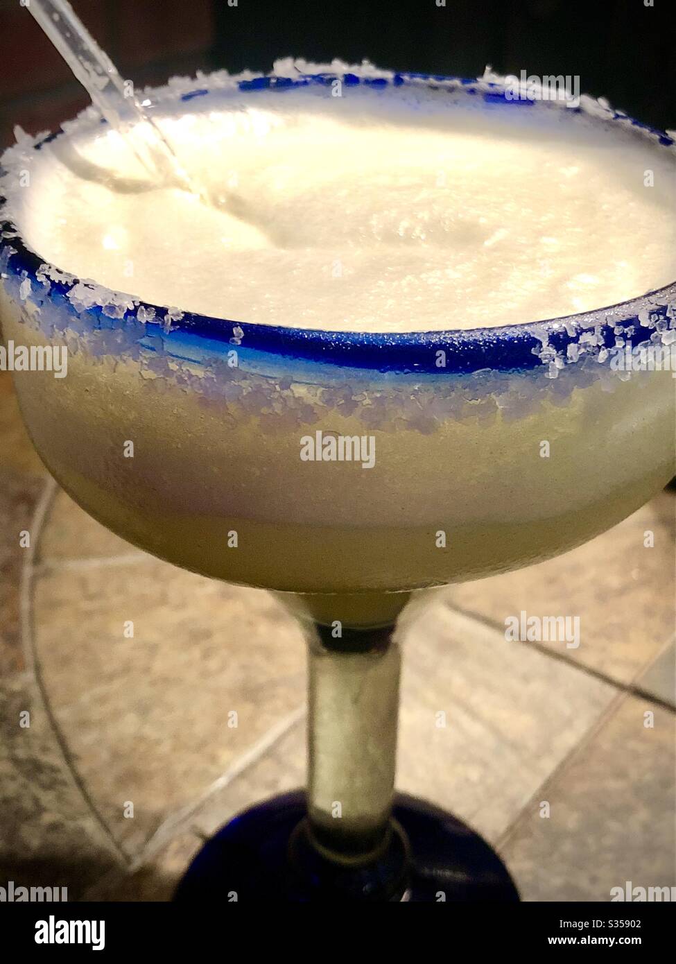 Margarita in a blue rimmed glass with salt Stock Photo