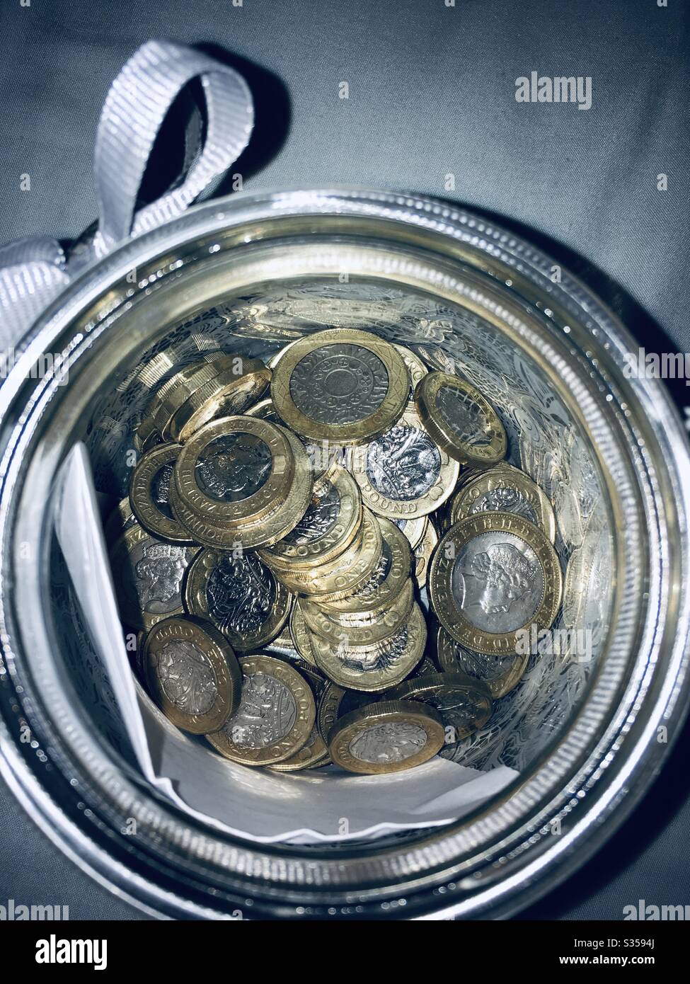 Pot of one pound coins Stock Photo