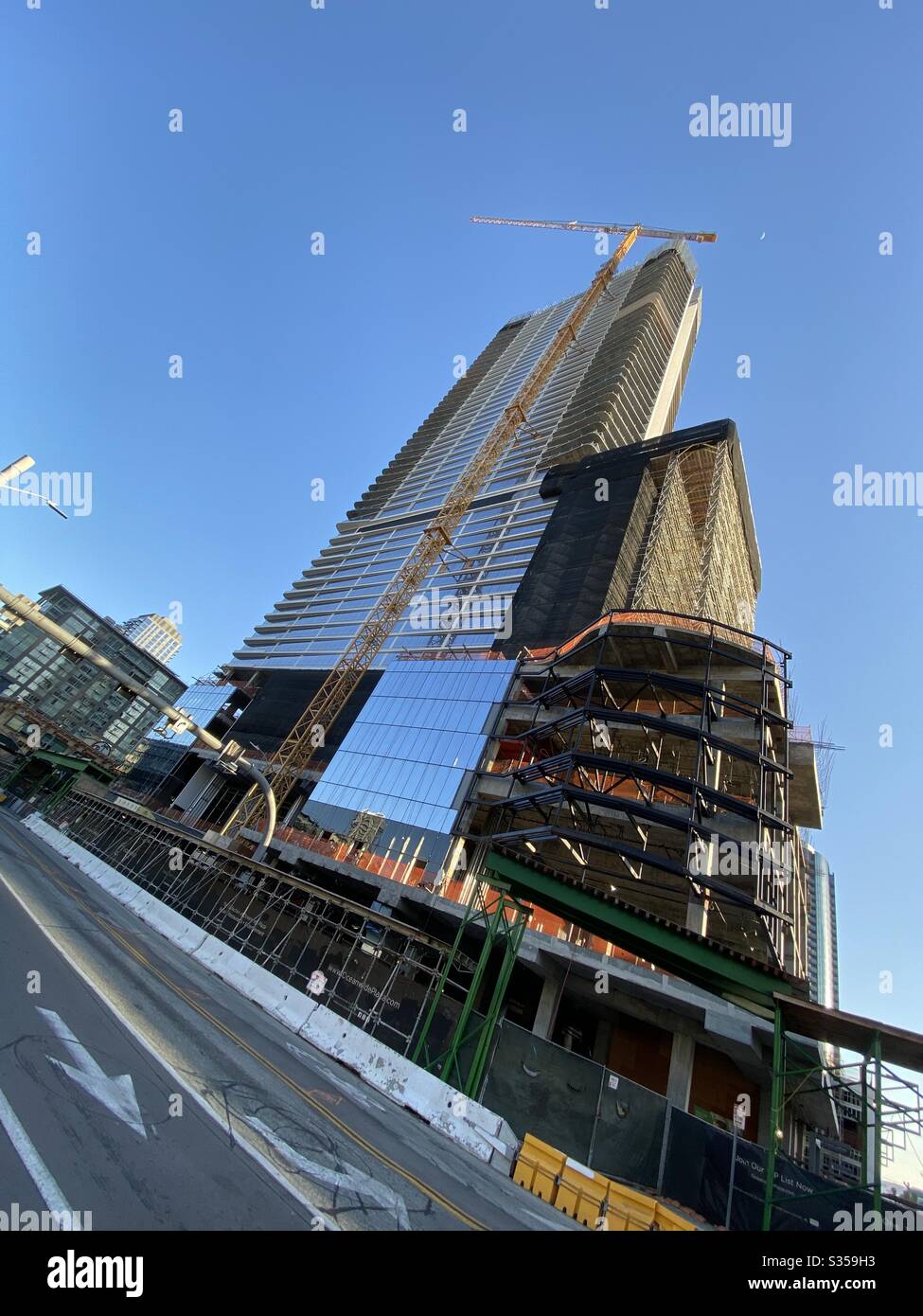 LOS ANGELES, CA, MAR 2020: new skyscraper construction at Oceanwide Plaza, near Staples Center and LA Live sports and entertainment venues in South Park area of Downtown. Angled view with street. Stock Photo