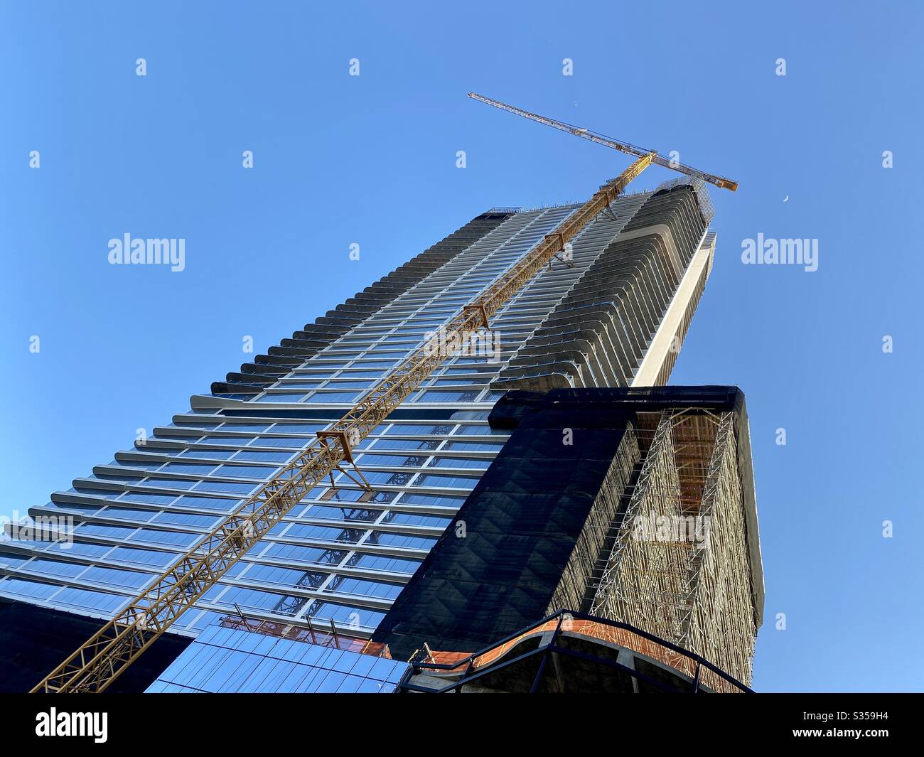 LOS ANGELES, CA, MAR 2020: angled view, looking up at new skyscraper construction at Oceanwide Plaza, near Staples Center and LA Live sports and entertainment venues in South Park area of Downtown Stock Photo