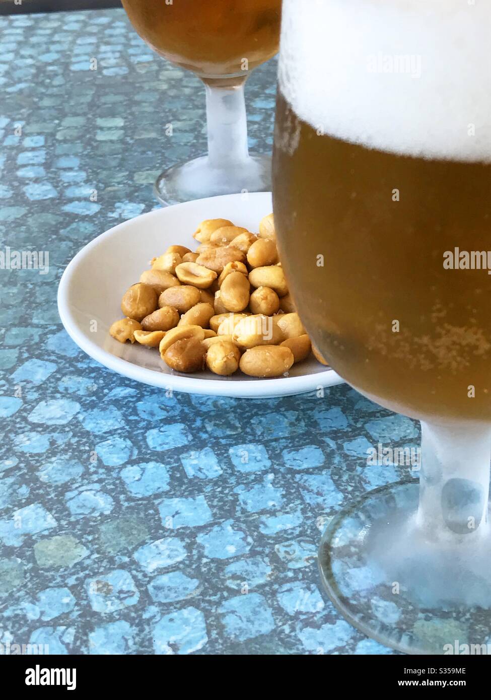 Glass of beer with peanuts - Smartphone Captured Stock Image