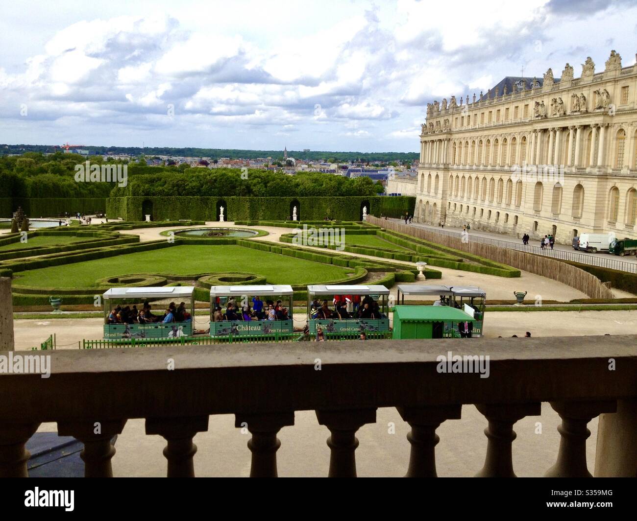 Tourist trains, Château Petit and Grand Trianon, travel through Versailles and it’s gardens with beautiful scenery in the background, France. - Smartphone Captured Stock Image Tourist trains, Château Petit and Grand Trianon, travel through Versailles and it’s gardens with beautiful scenery in the background, France. - Smartphone Captured Stock Image