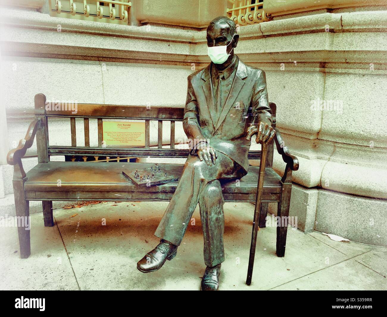 NYC statue of Lech Kaczynski with a face mask during the coronavirus pandemic in front of the Consulate General of Poland building in midtown Manhattan, NYC, USA - Smartphone Captured Stock Image