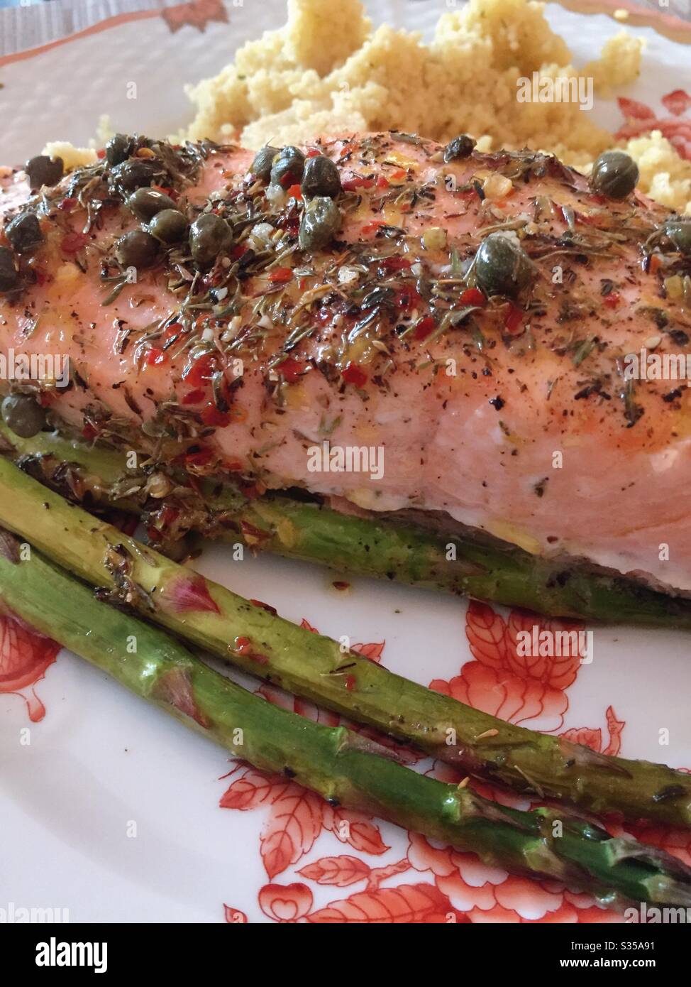 Close up of a gourmet meal of baked salmon, fresh asparagus spears and couscous - Smartphone Captured Stock Image
