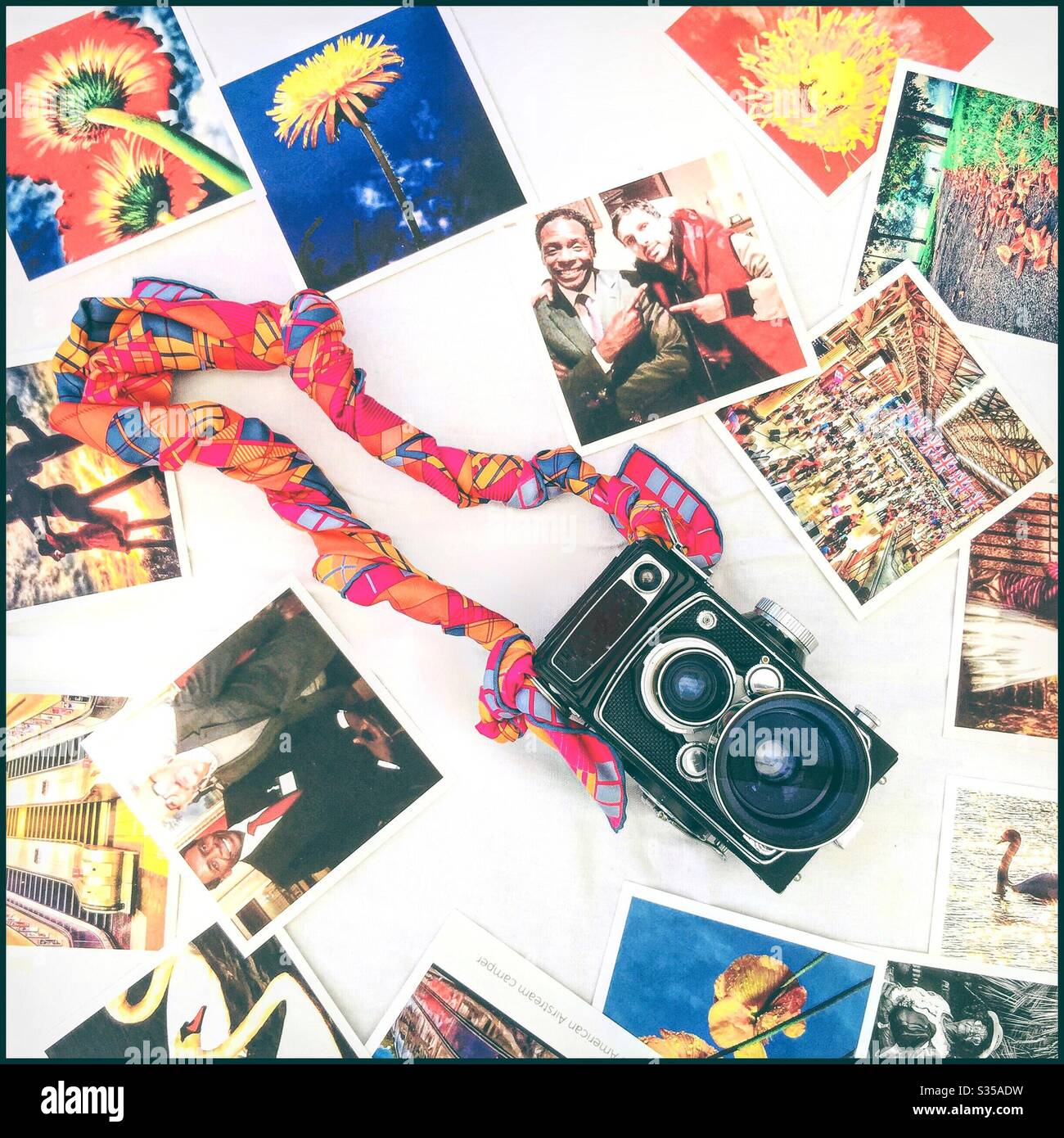 Retro camera, silk scarf and photographs. - Smartphone Captured Stock Image