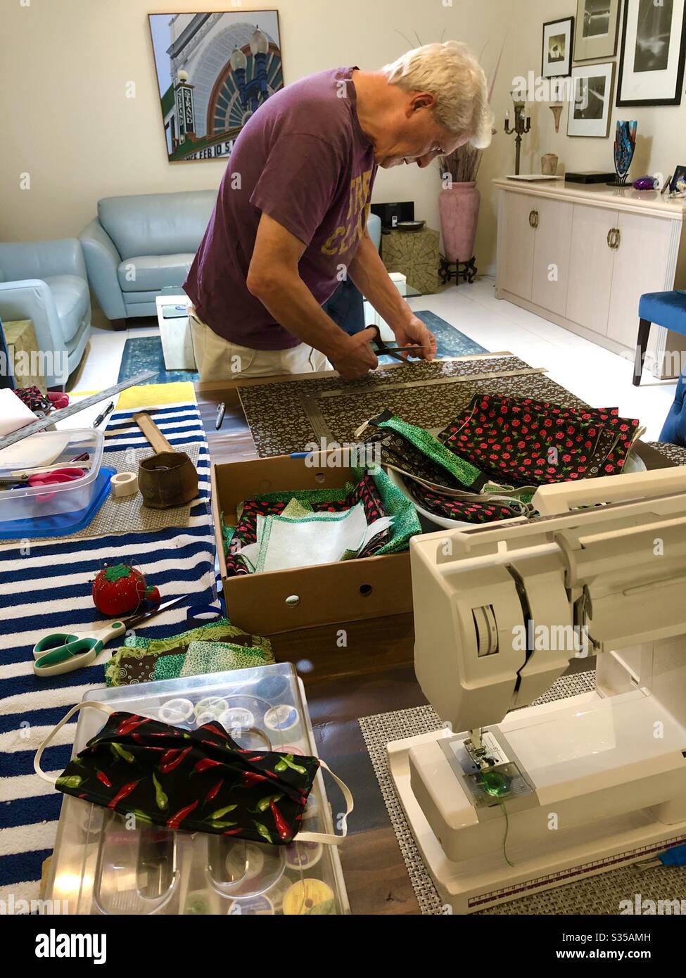 Volunteering at home to make homemade non-surgical masks for the community during the coronavirus pandemic 2020. - Smartphone Captured Stock Image
