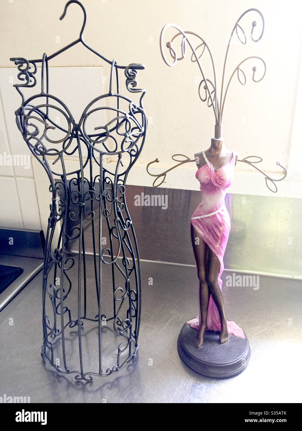 Wrought iron and figurine models for hanging jewellery Stock Photo