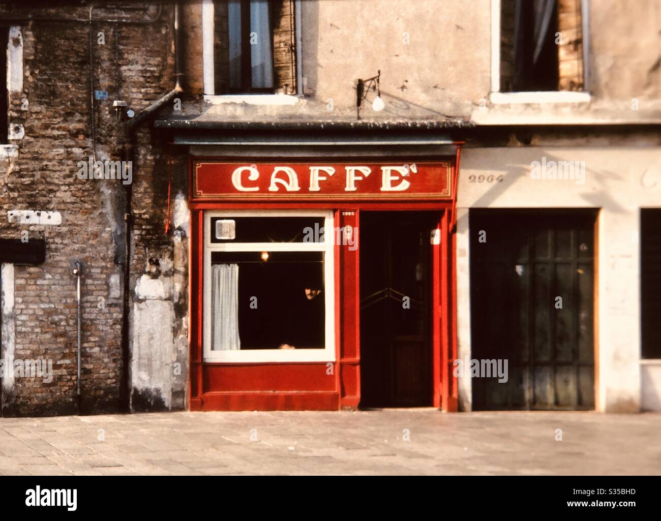 Man at window of cafe Venice Italy empty town square - Smartphone Captured Stock Image