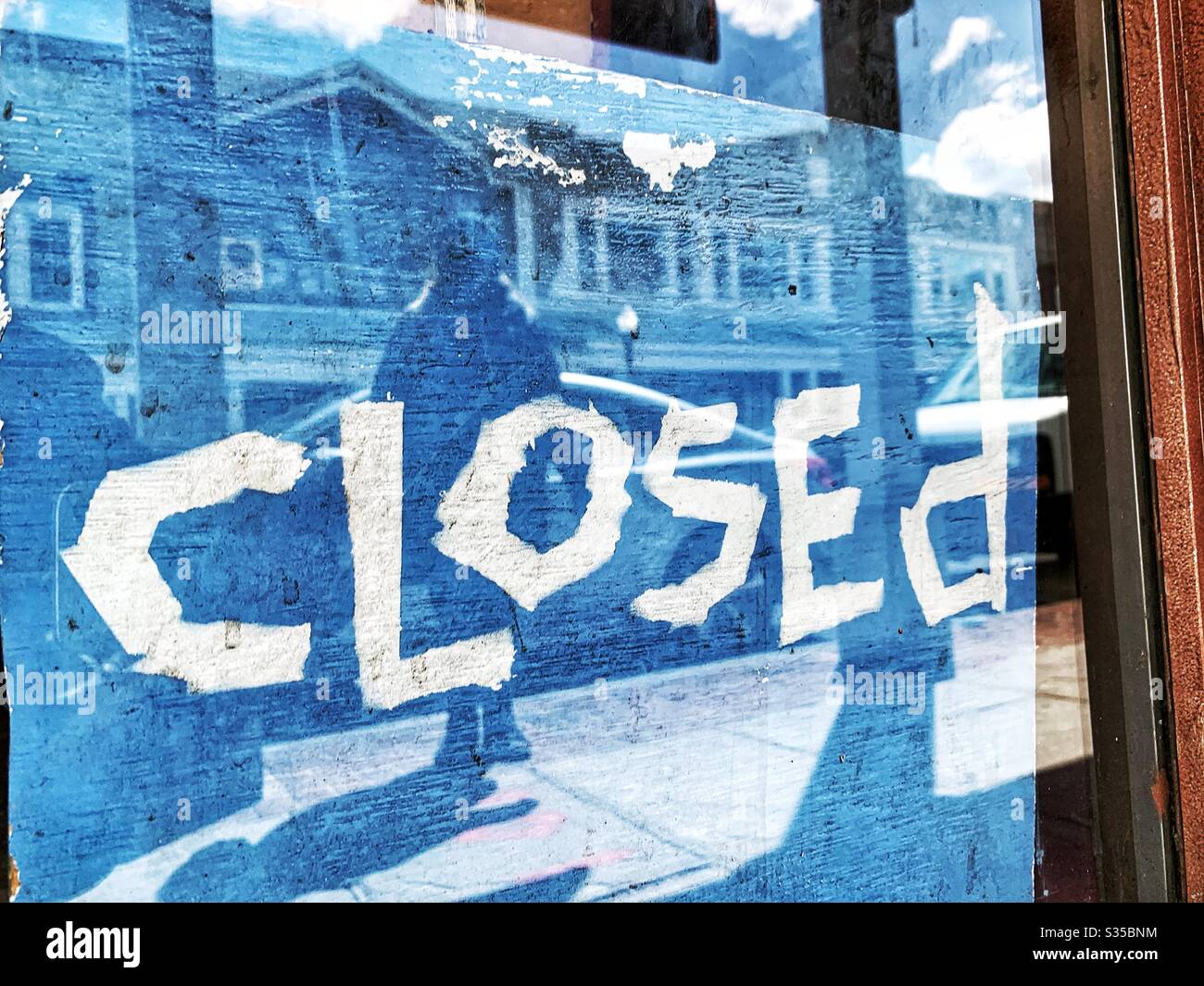 Hand made,  closed sign at restaurant customer standing looking on with dismay  no take away Stock Photo