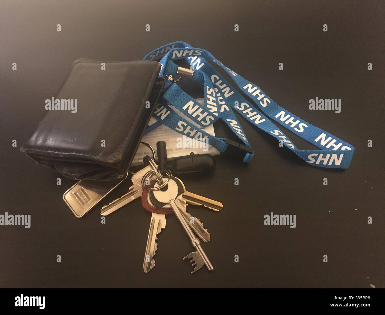 House and car keys, wallet, mobile phone and face mask on wooden surface.  Ready to go out in the new world Stock Photo - Alamy