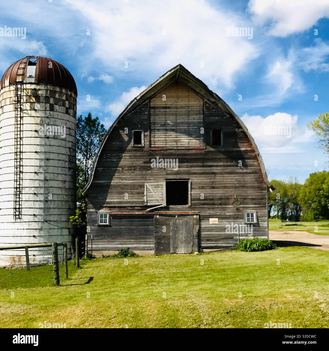 Old wooden barn and silo Stock Photo