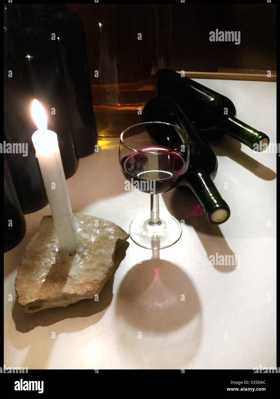 Bottling Syrah wine by candlelight, Catalonia, Spain. - Smartphone Captured Stock Image