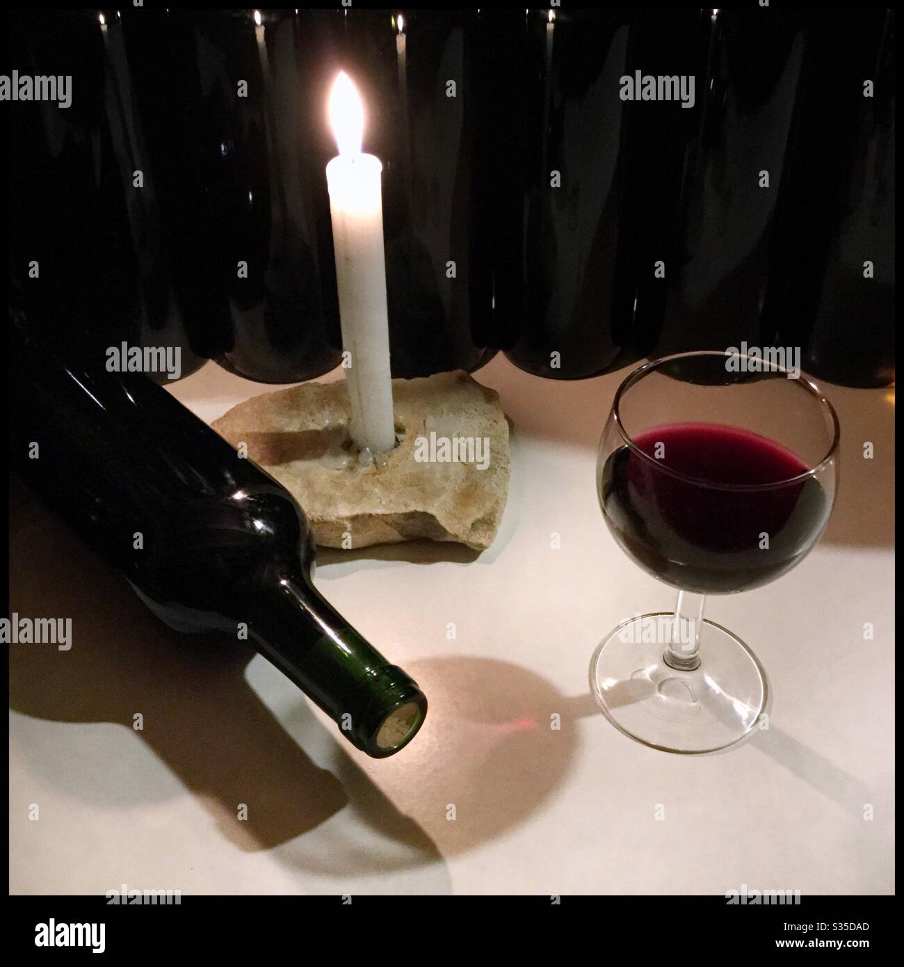 Bottling Syrah wine by candlelight, Catalonia, Spain. - Smartphone Captured Stock Image