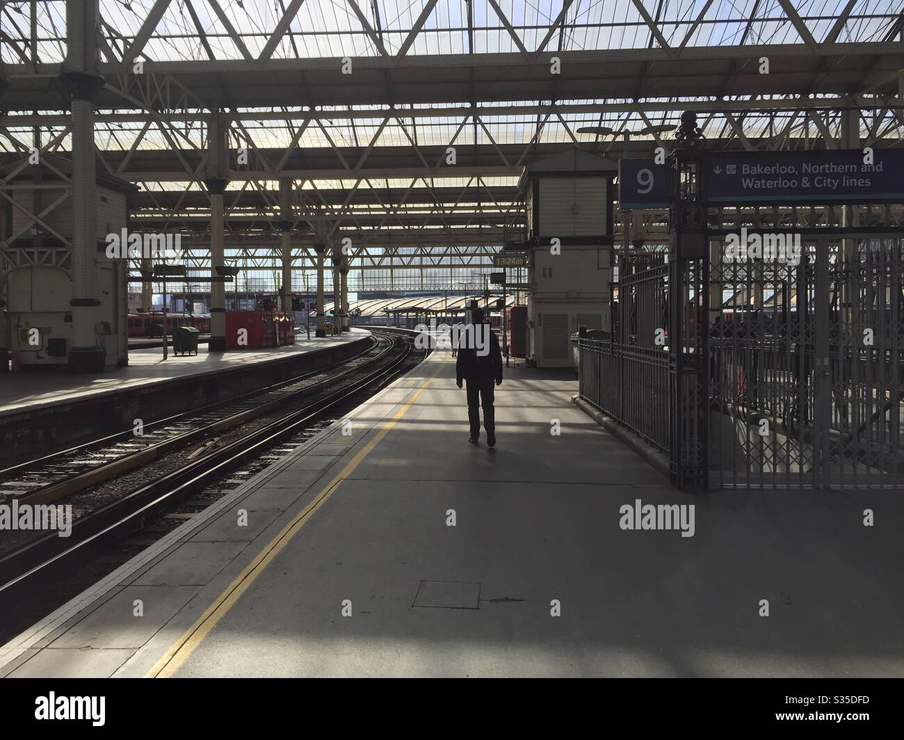 Waterloo Station 1330 hours covid virus lockdown on travel Coronavirus London empty railway station - Smartphone Captured Stock Image
