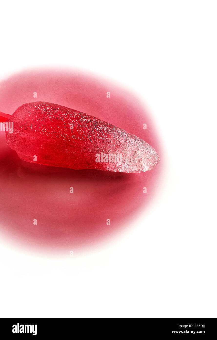 Melting red ice lolly on white background - Smartphone Captured Stock Image
