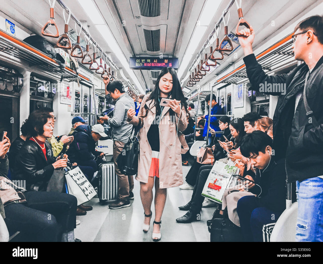 Passengers on a busy train on the Seoul underground system. - Smartphone Captured Stock Image