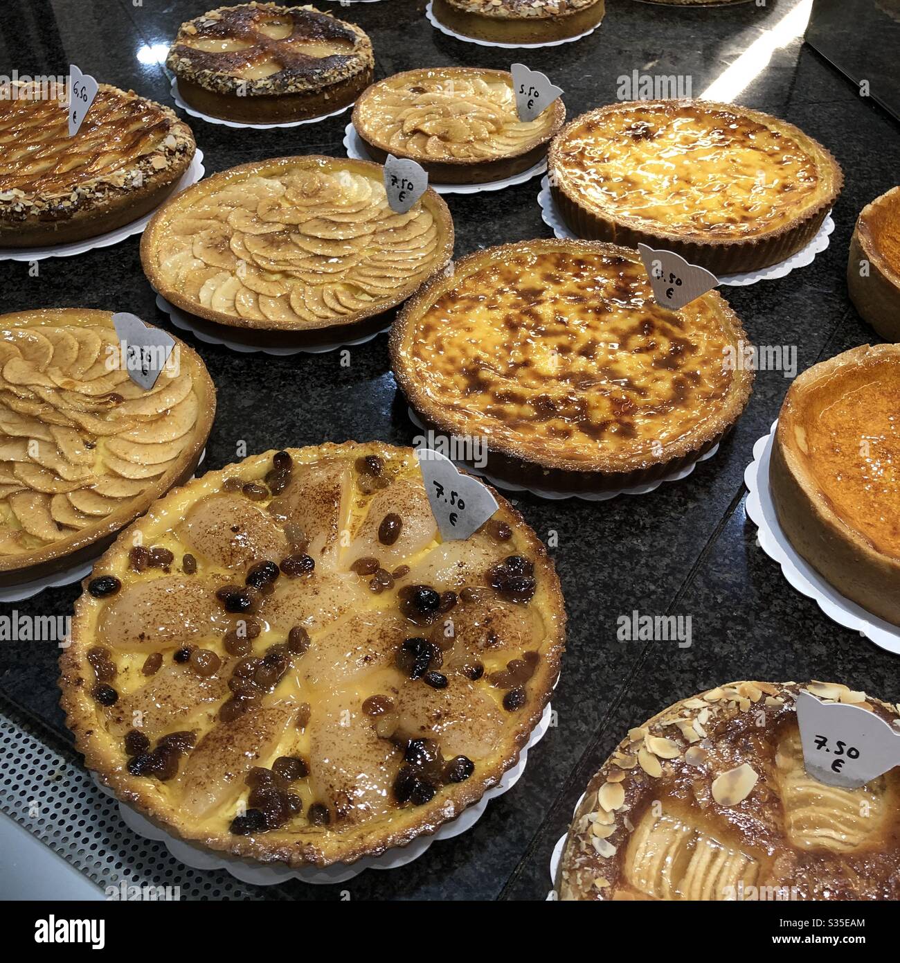 Apple tarts on display in baker’s shop window - Brussels, Belgium. - Smartphone Captured Stock Image