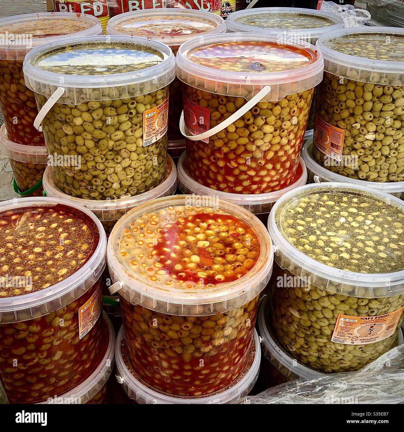 Tubs of spiced olives in Arab market, Brussels, Belgium. - Smartphone Captured Stock Image