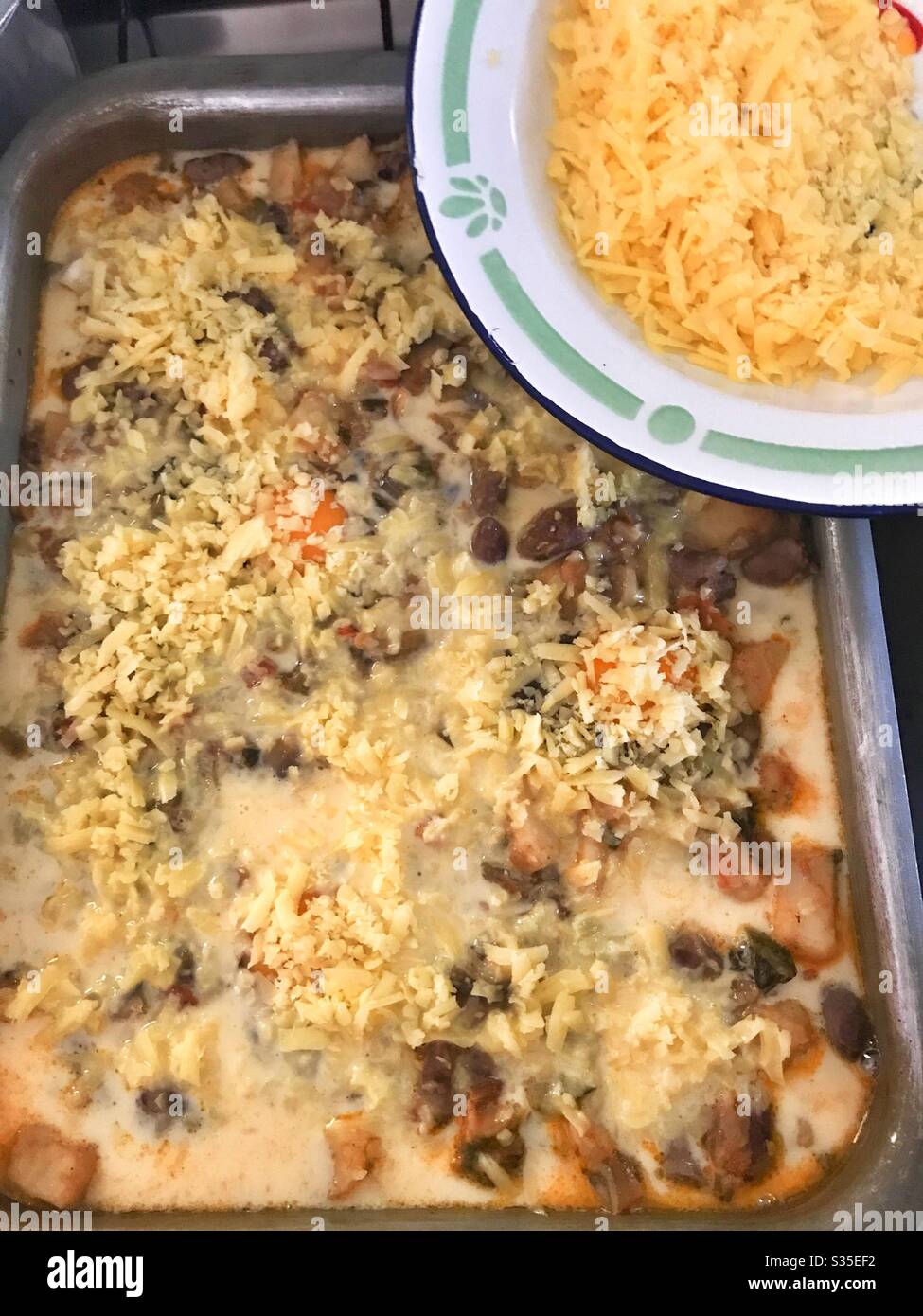 Cheese sprinkled over a precooked sweet potatoes casserole - Smartphone Captured Stock Image