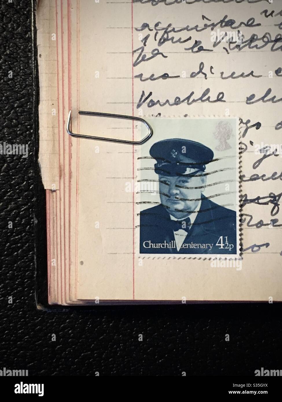 Winston Churchill commemorative stamp on a notebook hand written Stock Photo