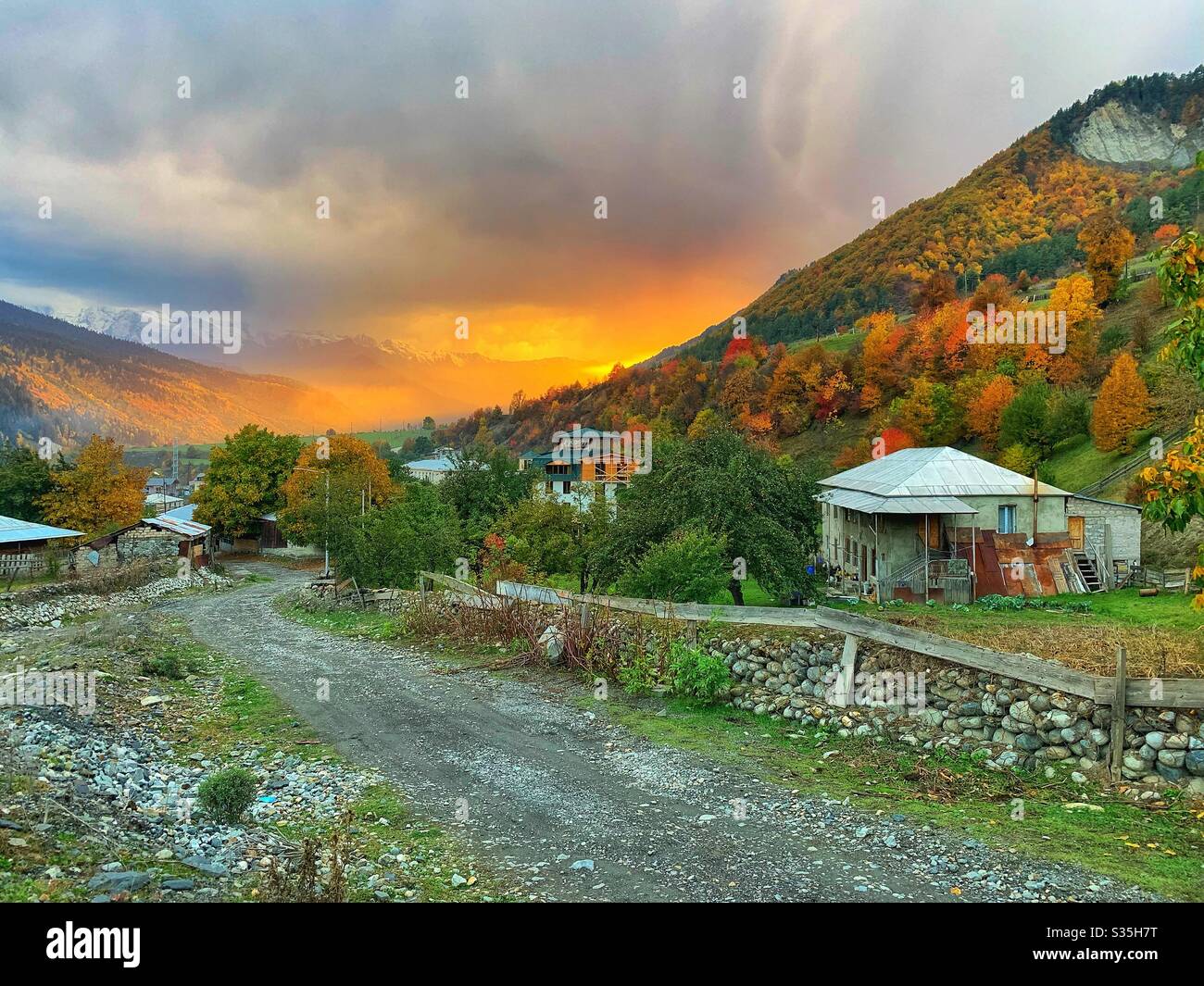 Mountain on fire! A mesmerising sunset amidst an almighty thunder storm in the Caucasus Mountains, Mestia, Georgia. - Smartphone Captured Stock Image