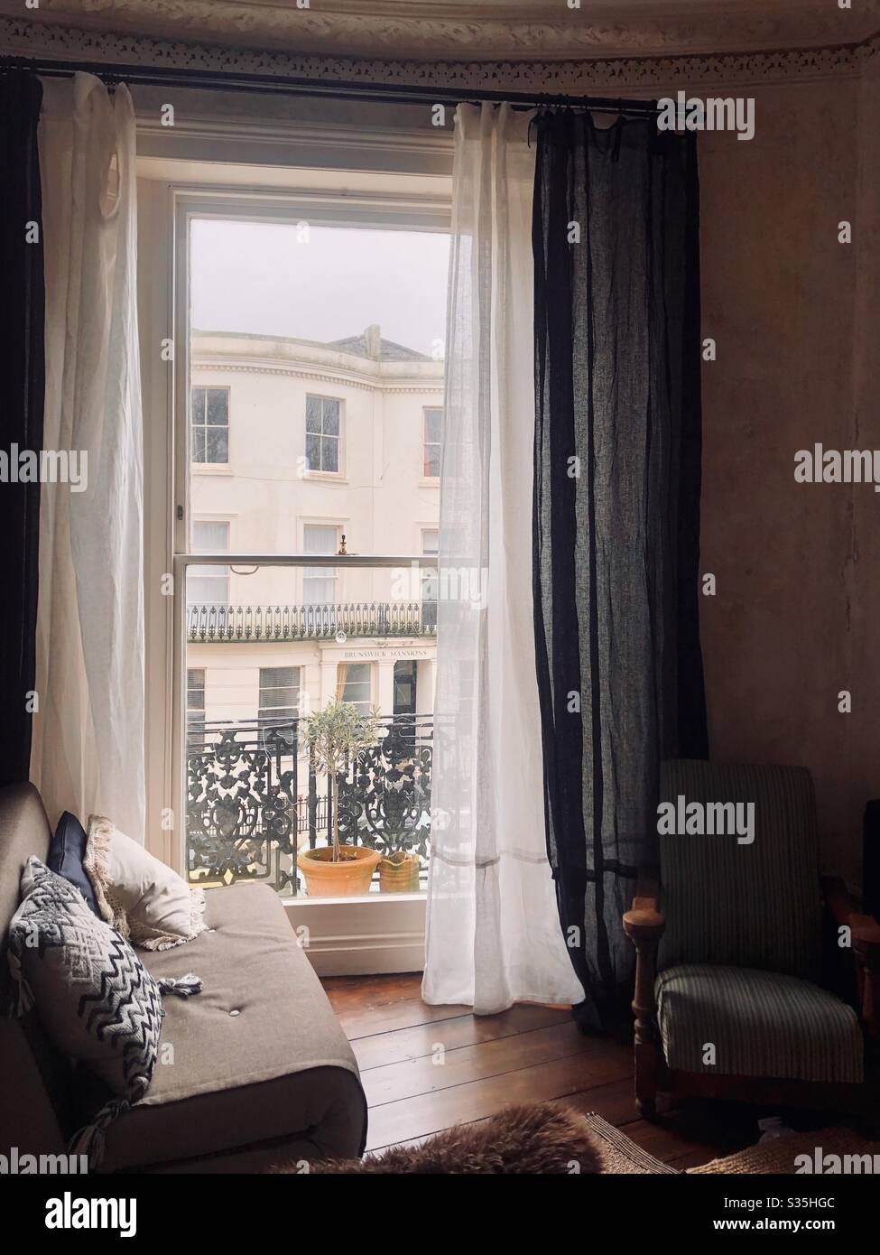 View through a floor to ceiling sash window of a Georgian regency building in Brunswick town, Hove. UK 2019. Stock Photo