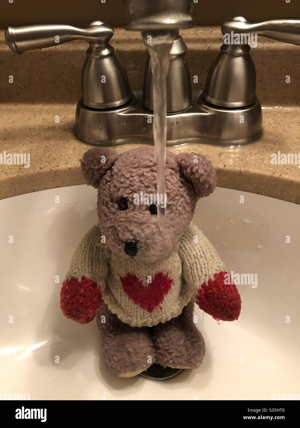 Bath time for a cute stuffed teddy bear. - Smartphone Captured Stock Image