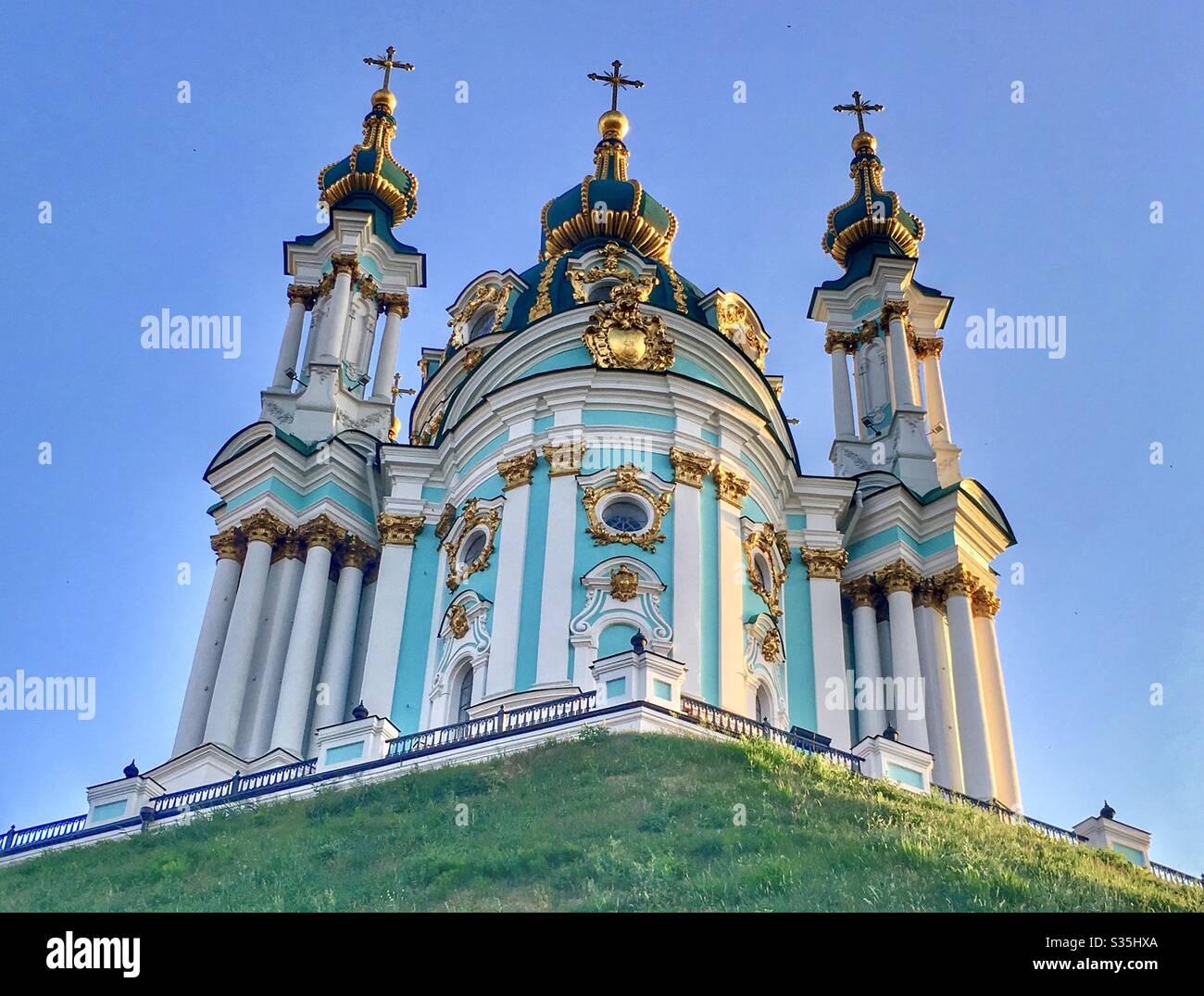 At Andrews Church, Kiev. An ornate blue, white and gold place of worship with a domed roof, turrets and intricate detailing. - Smartphone Captured Stock Image