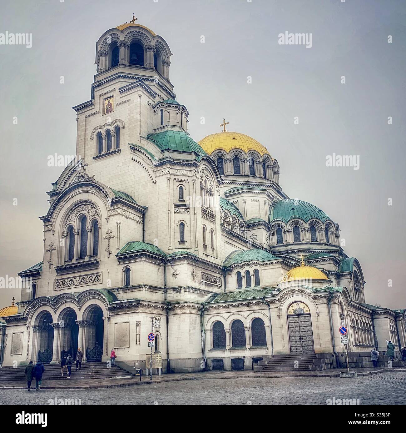 St. Alexander Nevsky Cathedral. Orthodox Church with green and gold domed ceilings in Sofia, Bulgaria on a cloudy day. - Smartphone Captured Stock Image