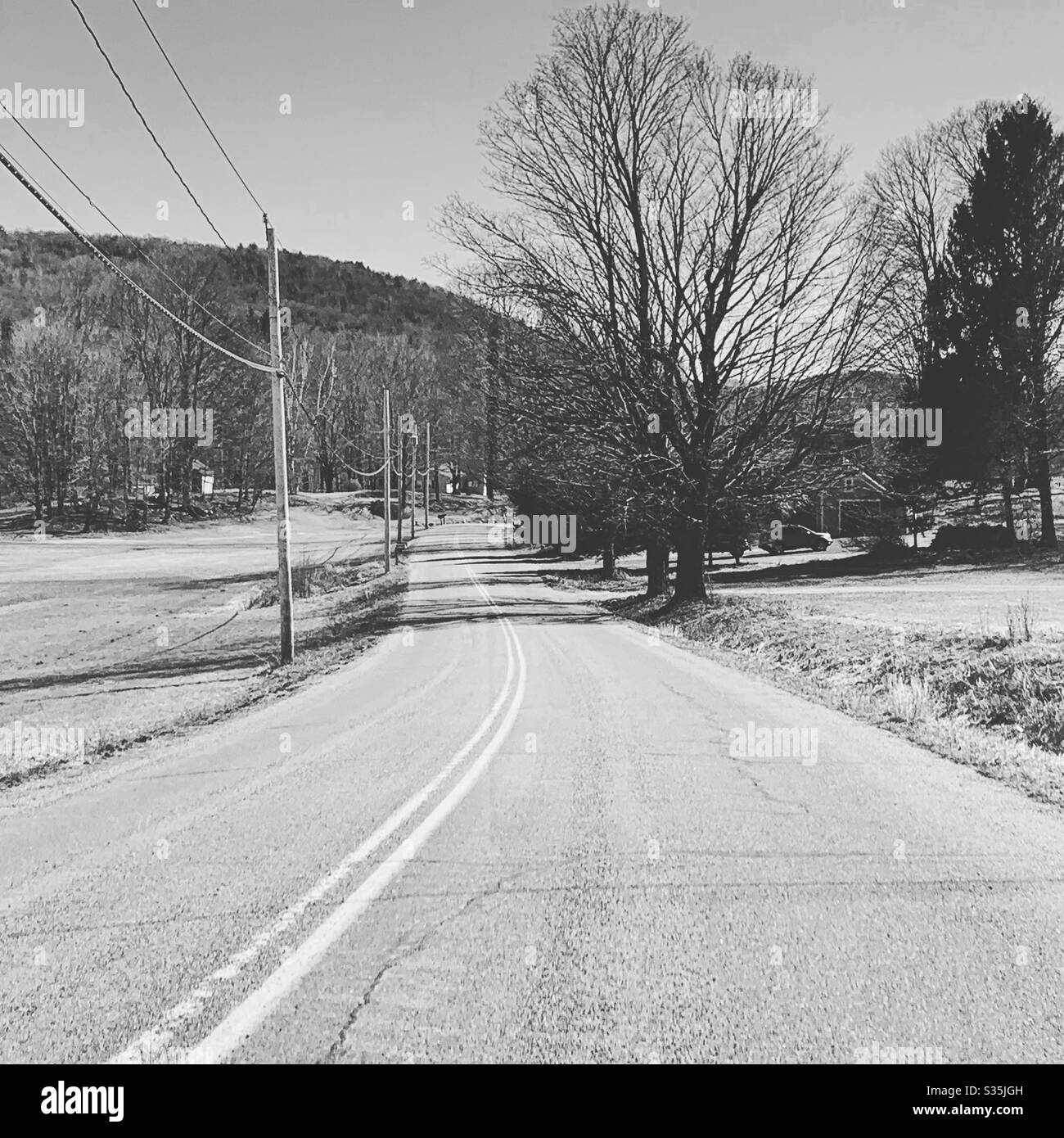 Black and white image of a rural road in New England, United States - Smartphone Captured Stock Image
