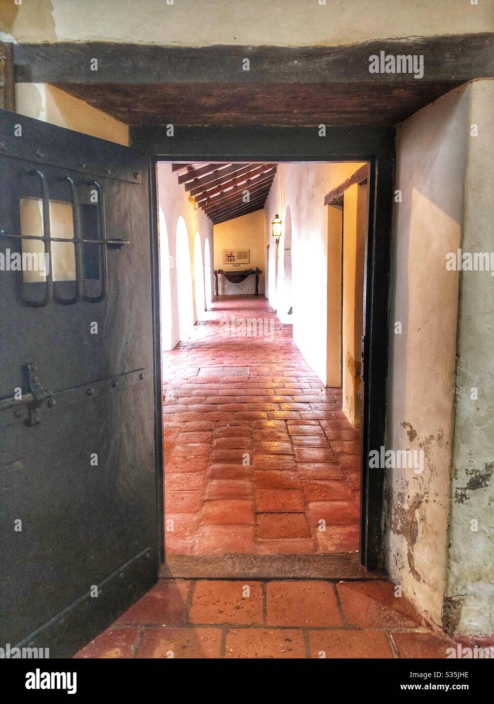 Looking through an open door down an empty corridor of a historical colonial building in Salta, Argentina. - Smartphone Captured Stock Image