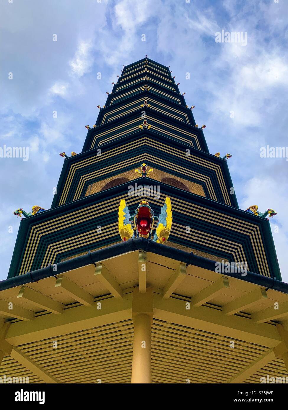 The Great Pagoda, Kew Royal Botanic Gardens, London. A unique view of the pagoda reaching into a blue sky, highlighting the dragons which adorn the structure. - Smartphone Captured Stock Image
