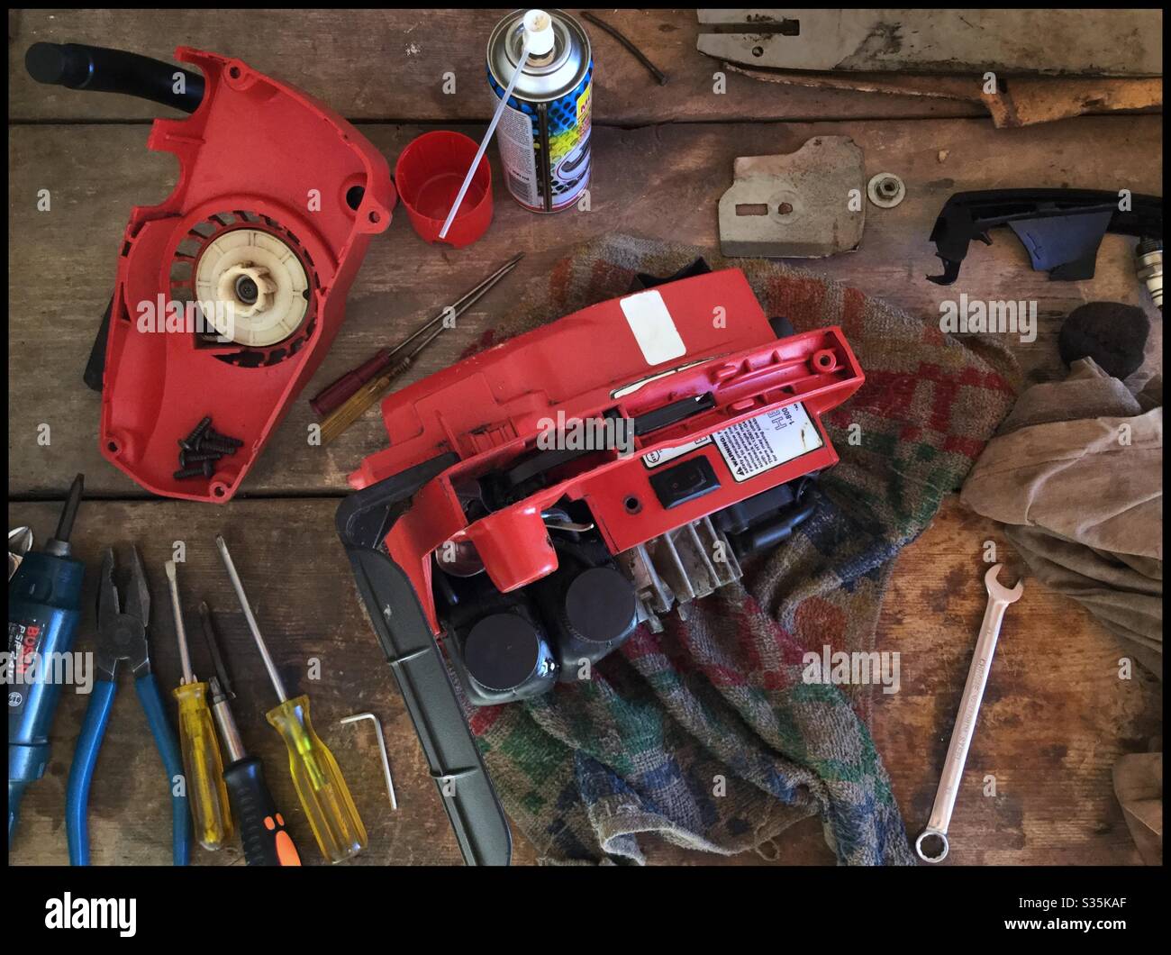 Repairing a Homelite chainsaw, Catalonia, Spain. - Smartphone Captured Stock Image
